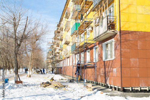 Warming of the apartment house. External repair work on the building, insulation and cladding of the facade of the house © ALEXEY