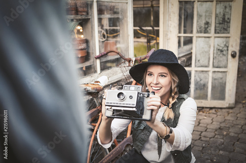 Woman taking a photo with vintage camera