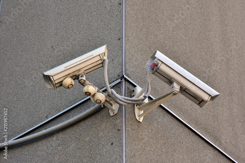 the surveillance camera on a wall of old building photo