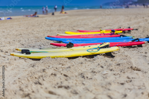 Many colorful surfboard in sand beach