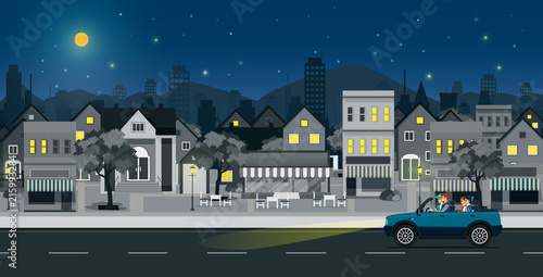 Families drive on city streets at night.