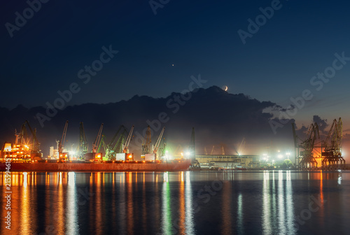 Industrial cranes and cargo ships in Varna port, Bulgaria at sunset © ValentinValkov