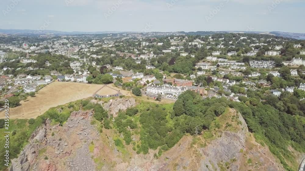 Aerial view of the town of Torquay in southwest England. Coastal town in Devon. Cliffs and agricultural land is visible. Aerial view of the town of Torquay in southwest England. Coastal town in Devon. Cliffs and agricultural land is visible.