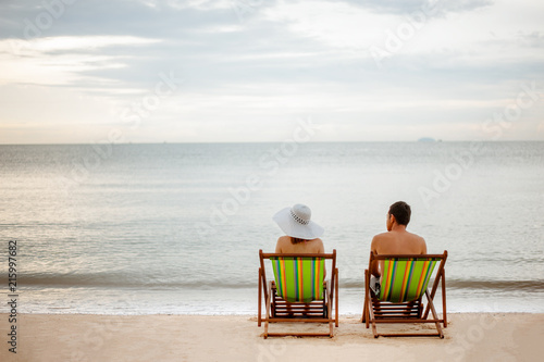 Couple in loungers on a tropical beach © Day Of Victory Stu.
