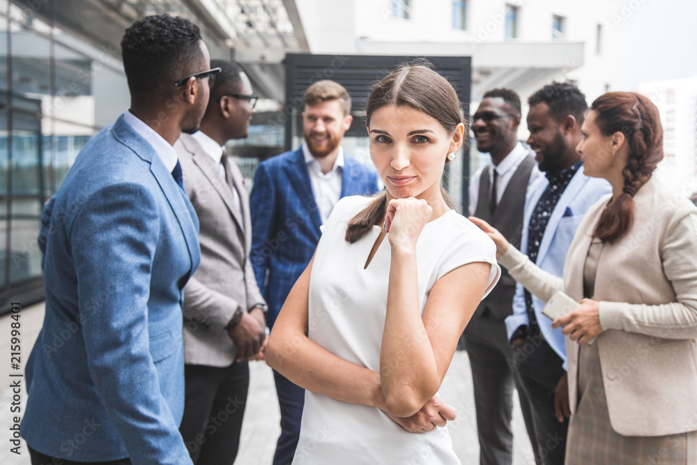 Portrait of an handsome businesswoman in front of his team. recognition, movement on the career ladder, success in business Portrait of an handsome businesswoman in front of his team. recognition, movement on the career ladder, success in business