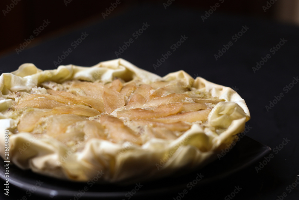Apple cake with almond cream on a dark background. Baked cake. Casserole Cooked in multivarts Proper nutrition. Pie for the whole family on a sunny day Apple cake with almond cream on a dark background. Baked cake. Casserole Cooked in multivarts Proper nutrition. Pie for the whole family on a sunny day