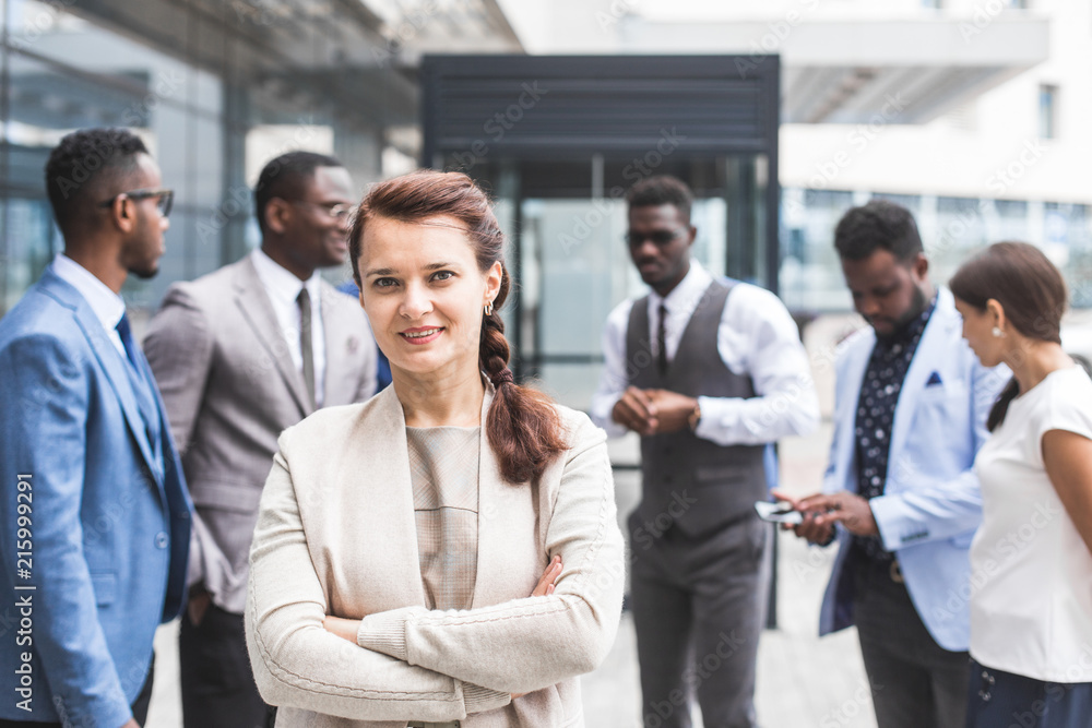 Portrait of an handsome businesswoman in front of his team. recognition, movement on the career ladder, success in business Portrait of an handsome businesswoman in front of his team. recognition, movement on the career ladder, success in business