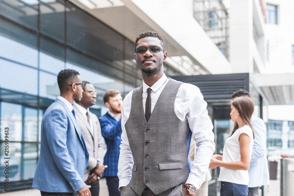 Portrait of an handsome businessman in front of his team. recognition, movement on the career ladder, success in business Portrait of an handsome businessman in front of his team. recognition, movement on the career ladder, success in business