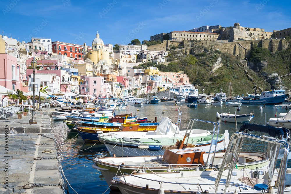 Beautiful view of traditional fishing boats moored in Corricella harbour on the island of Procida, Italy.