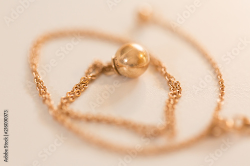 18K golden ball necklace isolated on white closeup