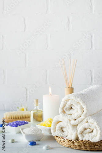 Body care set for peeling. With towel,white lily, sea salt, bath oil, sugar body scrub, massage brush and candle