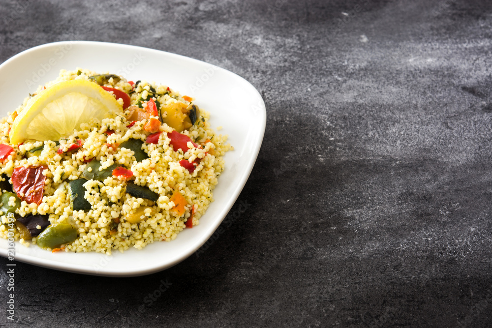 Couscous with vegetables on black stone. Copyspace Couscous with vegetables on black stone. Copyspace