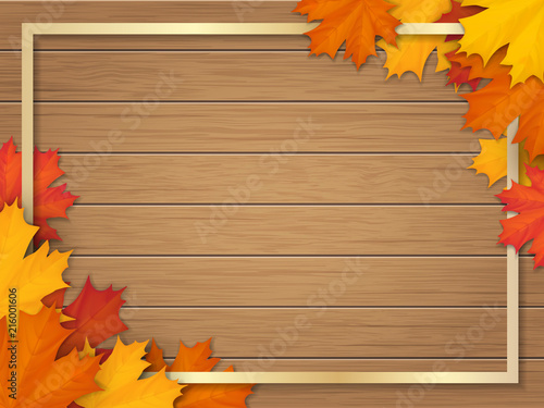 Golden frame decorated of fallen maple leaves. Autumn foliage on the background of a wooden vintage table surface. Realistic vector illustration.