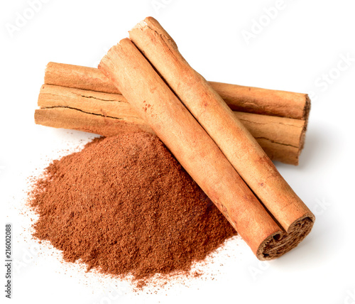 cinnamon powder and sticks isolated on white photo