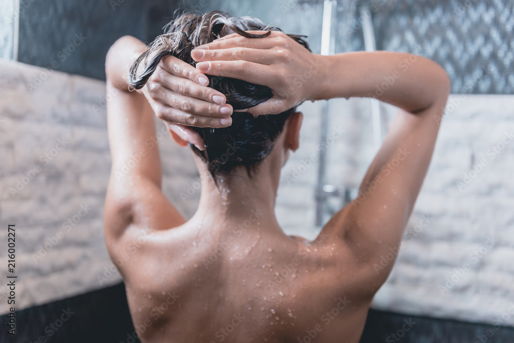 Back View of Beautiful Naked Young Woman in Shower