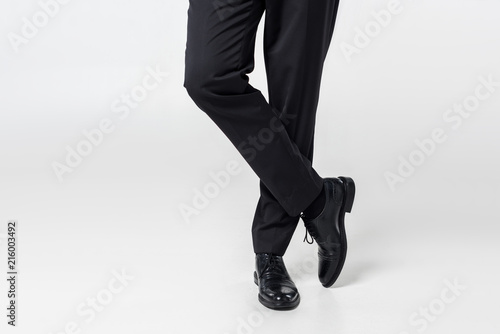 partial view of businessman in stylish clothing on grey background
