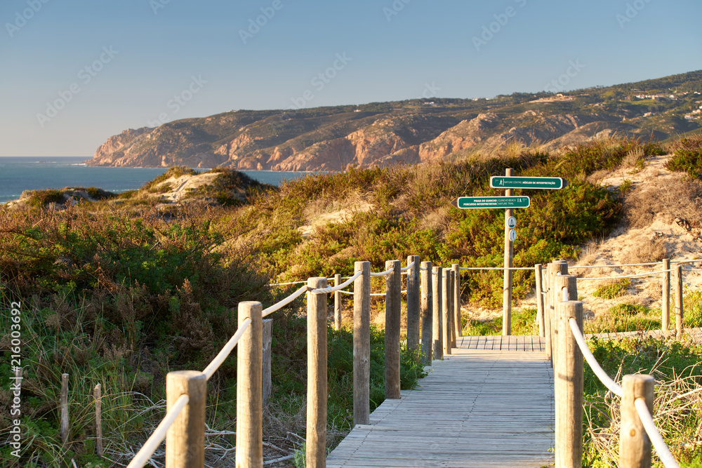 Praia do Guincho Beach pathway with indications to the beach coastline and sand dunes