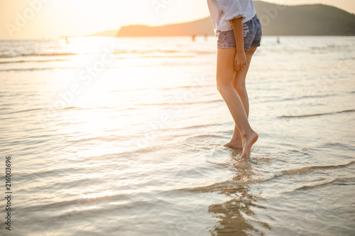 Woman Enjoying Beautiful Sunset on the Beach