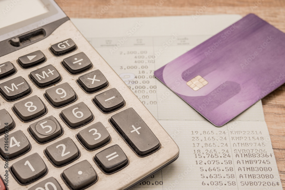 Calculator, cash card, bankbook Put on a wooden table. Calculator, cash card, bankbook Put on a wooden table.