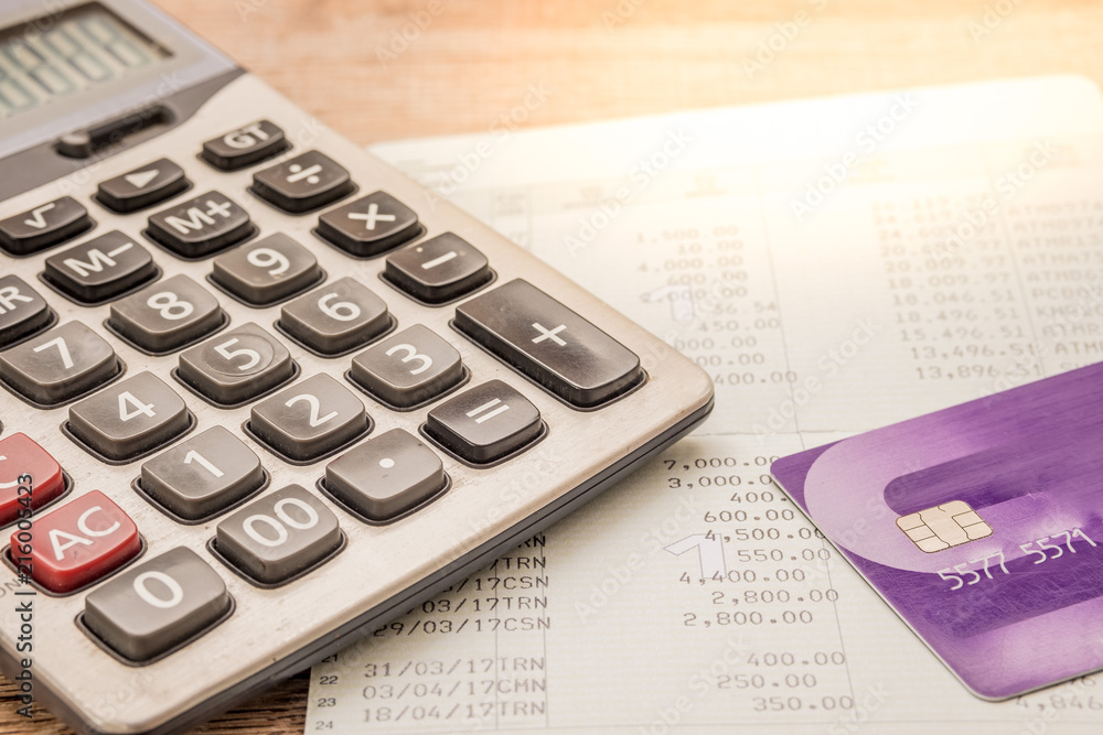 Calculator, cash card, bankbook Put on a wooden table. Calculator, cash card, bankbook Put on a wooden table.