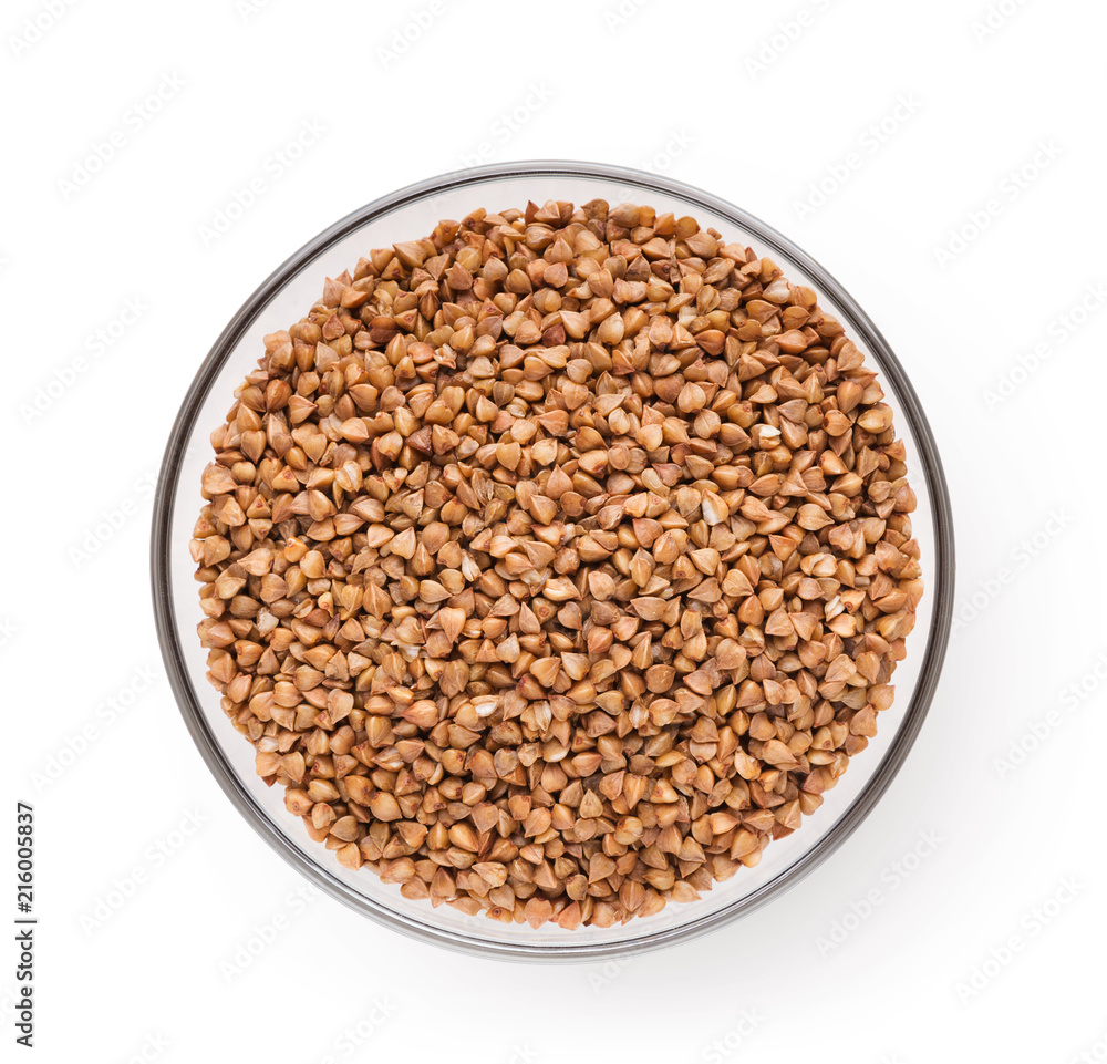Dry buckwheat in ceramic bowl isolated on white. Dry buckwheat in ceramic bowl isolated on white.