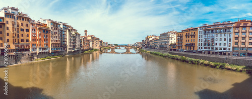 Panoramic view of colorful old buildings line the Arno River in Florence, Italy