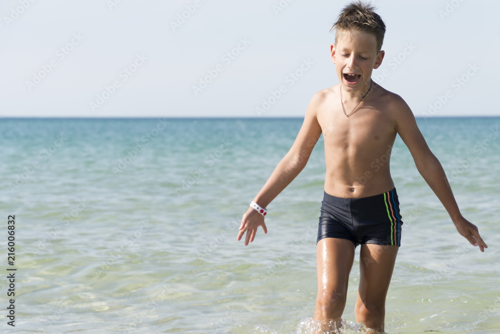 Cheerful boy sing a song on seashore background. childish spontaneity Cheerful boy sing a song on seashore background. childish spontaneity