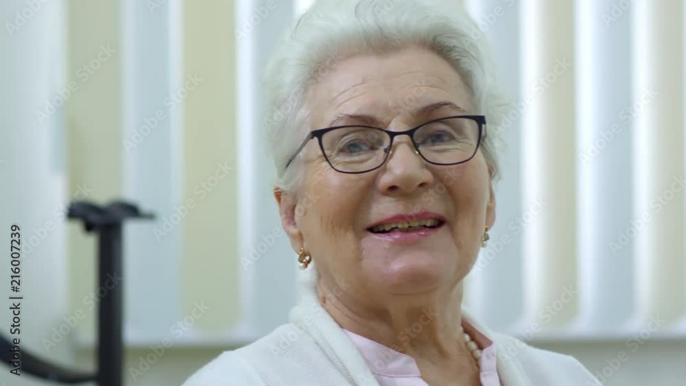 Portrait of happy senior woman in new eyeglasses smiling at camera in ophthalmology clinic Portrait of happy senior woman in new eyeglasses smiling at camera in ophthalmology clinic