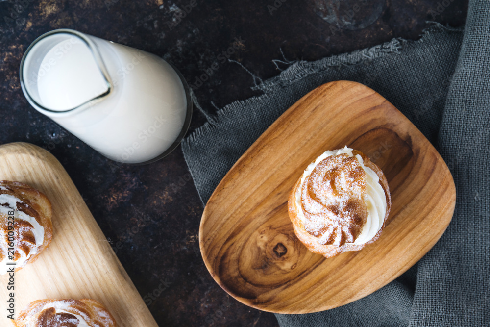 Choux pastry or choux cream or eclair dish on rustic background Choux pastry or choux cream or eclair dish on rustic background