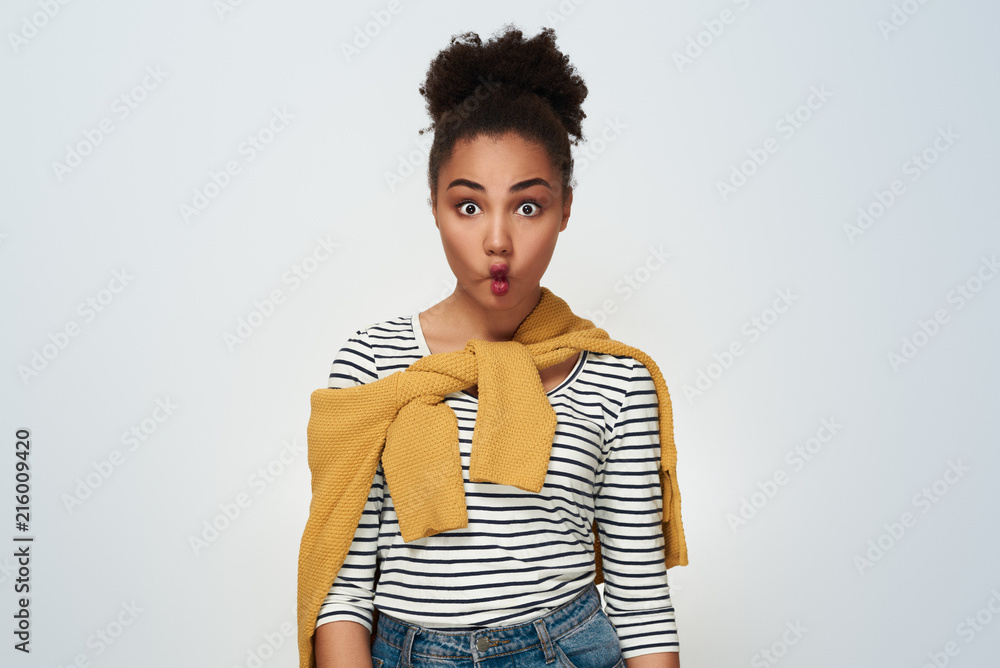Young woman studio isolated in white making fish lips silly Young woman studio isolated in white making fish lips silly