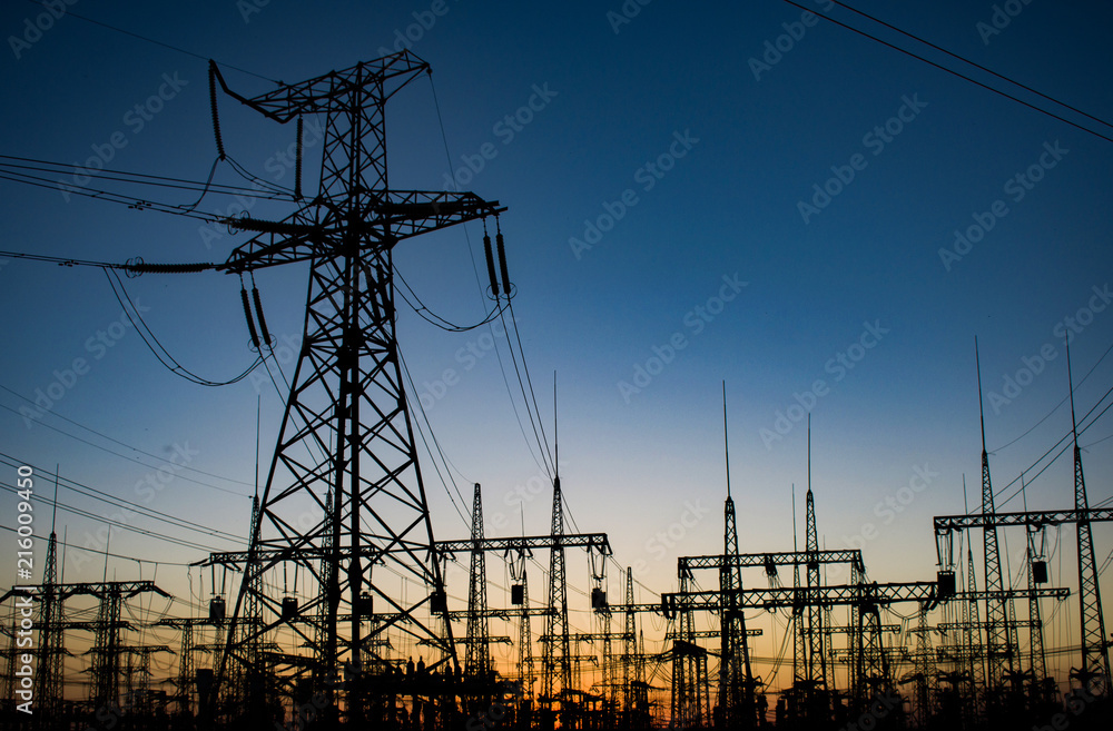 high-voltage power lines at sunset. electricity distribution station. high voltage electric transmission station