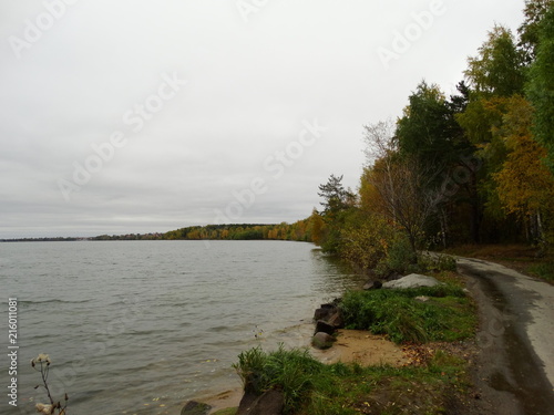 Road on the autumn shore of the lake. Shartash lake, Ekaterinburg, Russia