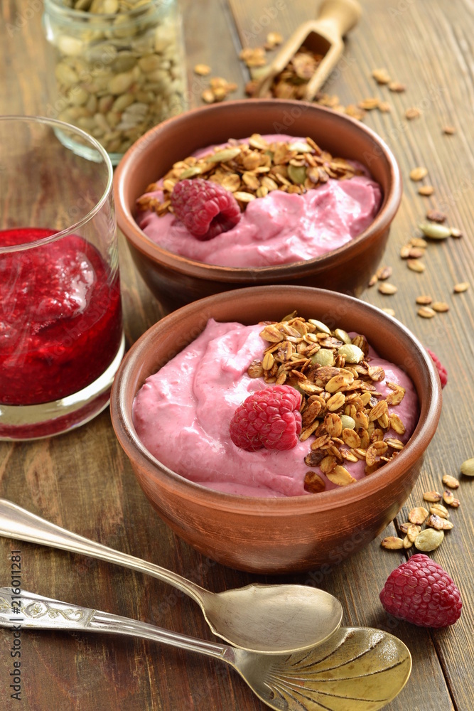Raspberry smoothie with granola and pumpkin seeds, vertical Raspberry smoothie with granola and pumpkin seeds, vertical