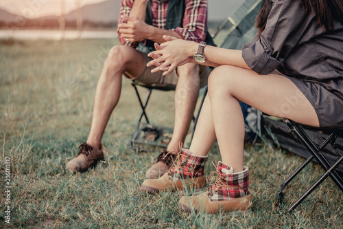 man and woman sitting in chairs on camp.