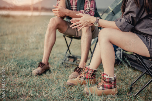 man and woman sitting in chairs on camp.