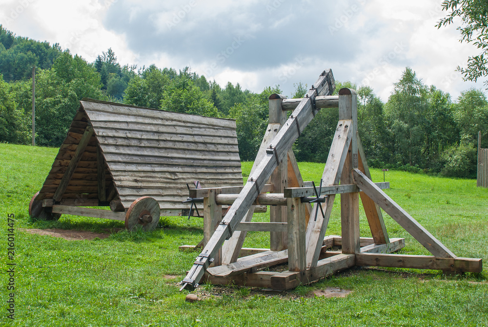 old wooden catapult, ancient combat weapon. old wooden catapult, ancient combat weapon.