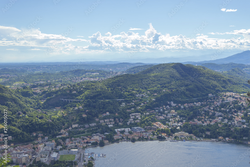 View of small town surrounded by mountains on the shores of Lake Como in Italy
