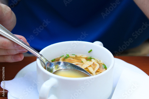 Man eating hot soup in beer garden photo