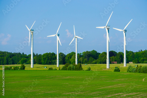 Windmill type wind electricity generator in the field in Latvia in summer