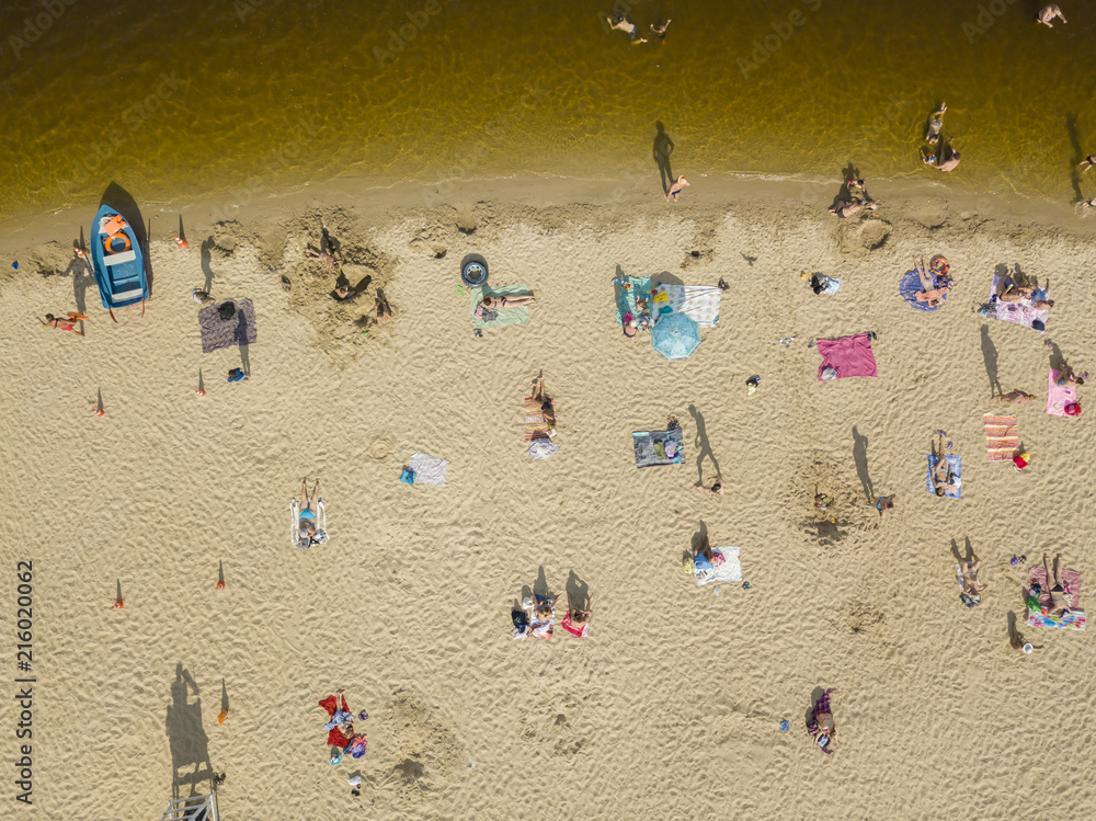 People enjoying the beach and swimming in the sea, aerial view People enjoying the beach and swimming in the sea, aerial view