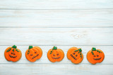 Halloween gingerbread cookies on white wooden table