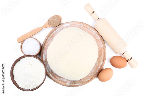 Raw dough with eggs and flour in bowl isolated on white background