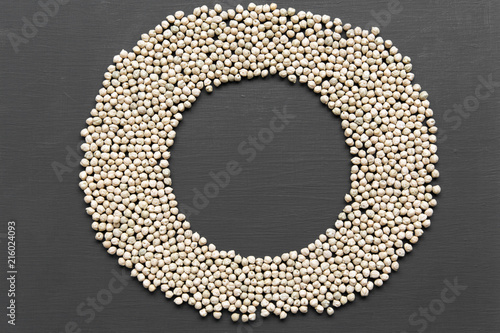 Creative layout of dried chickpeas on a black background, top view. From above, overhead.