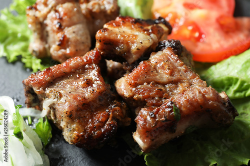 Tasty shish kebab served on slate plate, closeup