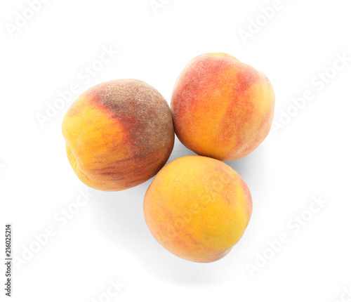 Fresh sweet peaches on white background