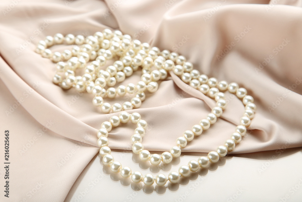 Pearl necklace with beige satin fabric Pearl necklace with beige satin fabric