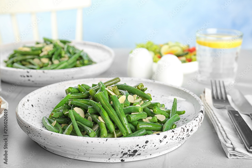 Tasty green beans with almonds served for dinner on table Tasty green beans with almonds served for dinner on table
