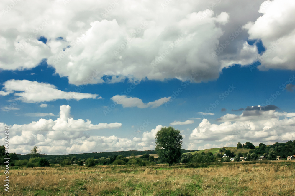 amazing clouds on blue sky and country side, beautiful summer nature landscape
