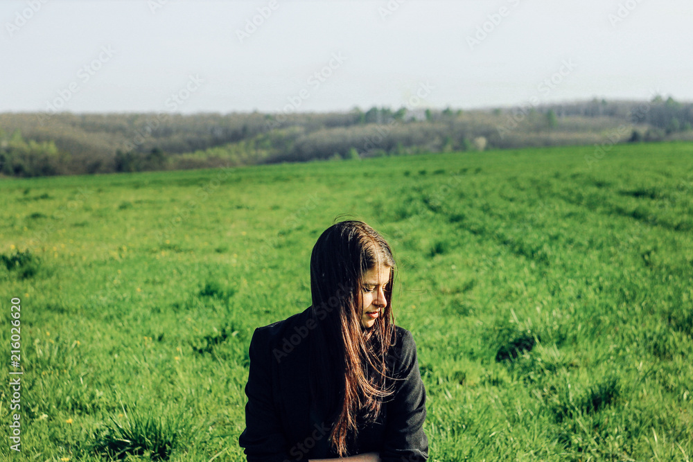 beautiful brunette girl in windy green field, sunny springtime, environment concept beautiful brunette girl in windy green field, sunny springtime, environment concept