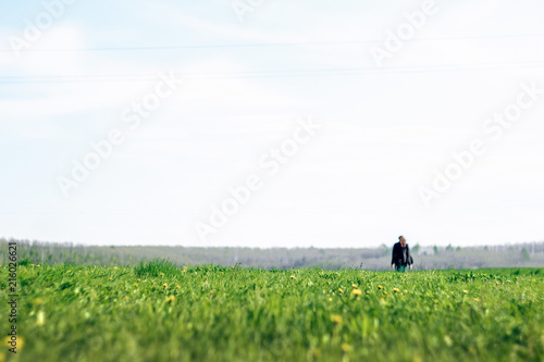 beautiful brunette girl in windy green field, sunny springtime, environment concept